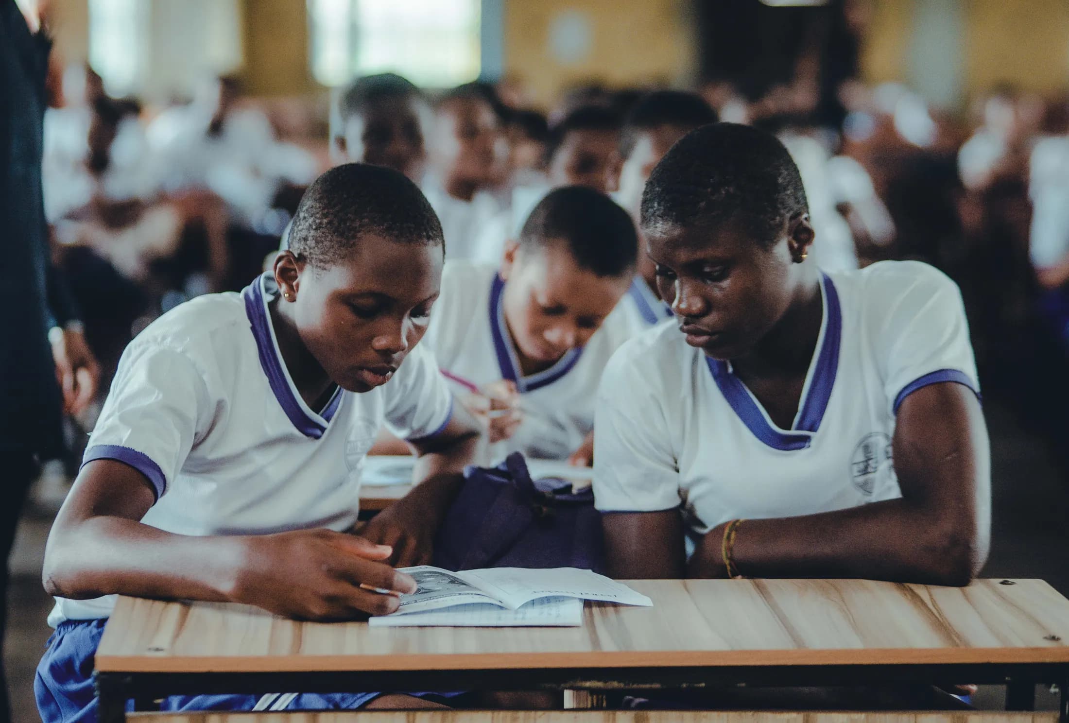 Illustrative stock photograph of African students studying together in a classroom; they are not shown taking part in a CVID-CAM program